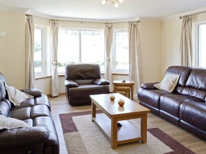 Enjoy the views of the river and hills beyond from the spacious living room area | March Cottage, Glen Cassley, near Lairg