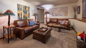Family Room with new leather furniture, spacious with fireplace and large TV