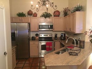 Kitchen hosts upgraded SS appliances and granite countertops