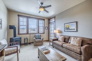 Living Area - Queen size sofa sleeper, access to the private balcony, and a gas fireplace.