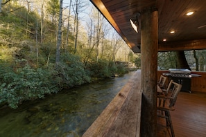 Enjoy the covered deck hanging over the river