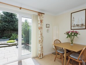 Spacious living/dining room with wood-burning stove and French doors | Camelot, Weybourne, near Holt