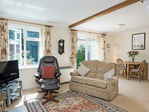 Spacious living/dining room with wood-burning stove and French doors | Camelot, Weybourne, near Holt