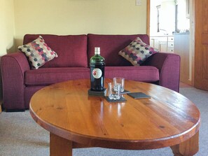 Relax and unwind in the warm and welcoming living room | The Pump House, Hawkesbury Upton