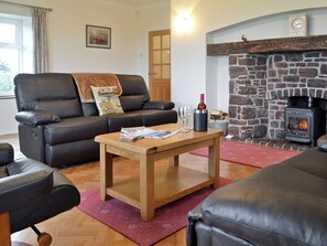 Living room with wood burning stove | Bwthyn Pereos, Cemlyn near Amlwch