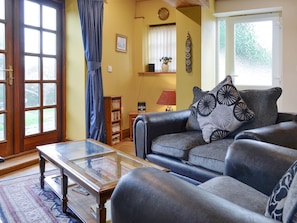 Cosy seating area overlooking garden | The Coach House at Old Vicarage Cottage, Betws-yn-Rhos, near Abergele