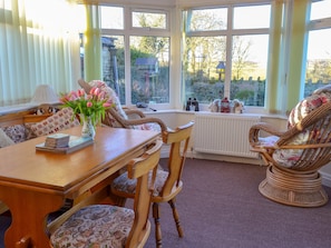 Conservatory with French doors leading to garden | Horcum View, Lockton, near Pickering
