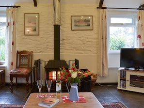 Cosy and warm living room with exposed stone wall | Trenay Barn Cottage, St Neot, near Liskeard