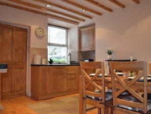Kitchen/diner with wooden floor and exposed beams | Duckling Cottage, Bowness on Windermere
