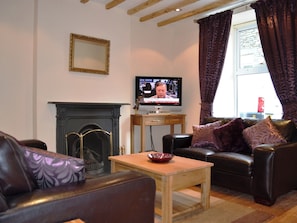 Living room with wooden floor and exposed beams | Duckling Cottage, Bowness on Windermere
