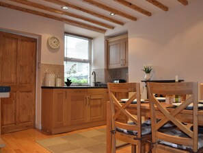 Kitchen/diner with wooden floor and exposed beams | Duckling Cottage, Bowness on Windermere