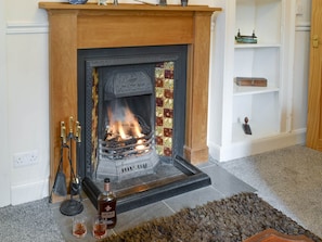 Feature fireplace within living room | Duffs Lodge - Beaufort Cottages, Kiltarlity, near Beauly