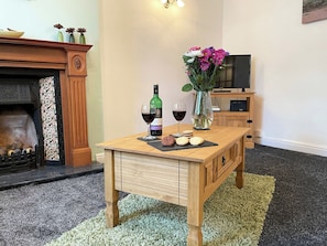 Comfortable living room with an open fireplace | Lavender Cottage, Keswick
