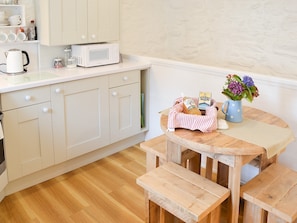 Modest dining area and adjacent well appointed kitchen | Hollies Cottage - Caerkief Farm, Goonhavern, near Perranporth