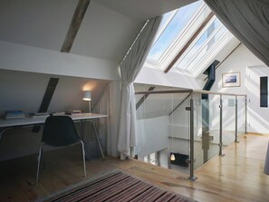 Impressive walkway with glass roof leading to galleried study area  | Madeleine’s Barn, Wells-next-the-Sea