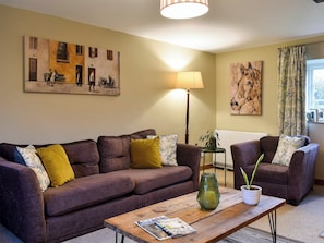 Cosy and warm living room with open fire | Barters Cottage, North Chideock, near Bridport