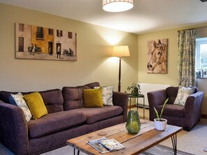 Cosy and warm living room with open fire | Barters Cottage, North Chideock, near Bridport