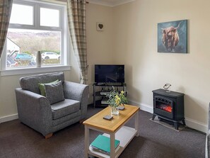 Comfortable and relaxing lounge area with electric stove effect fire, giving a cosy feel to the cottage | Kirnan Cottage, Kilmichael Glassary, near Lochgilphead