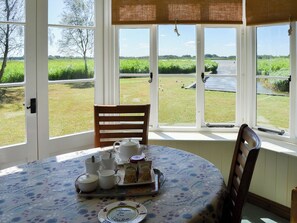 Dining area overlooking the lawned garden | The Studio, Hickling