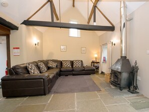 Living room with stone floor and beamed ceiling | The Old Forge, Kingston, near Corfe Castle