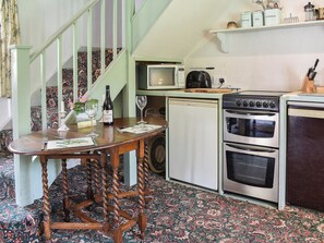 Kitchen and modest dining area | Cerne Abbey Cottage, Cerne Abbas