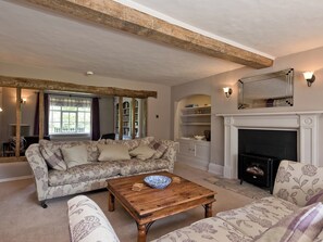 Spacious sitting room equipped with electric woodburner | Cravens Manor, Henham, near Southwold