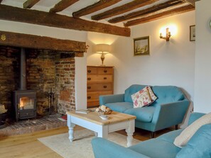 Comfortable living room with beamed ceiling | Three Ash Cottage, Bungay