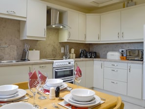 Fully appointed fitted kitchen with dining area | Mill Shore Cottage - Nethermill Cottages, Pennan, near New Aberdour
