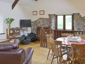 Cosy open-plan living space with wooden beams and wood floor | Homeleigh Barn - Burracott Farm, Poundstock, Bude