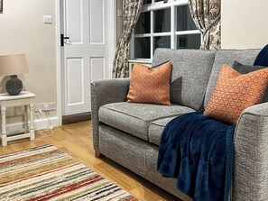 Comfortable living area and adjacent kitchen | The Farriers - The Abbey Coach House, St. Mary’s Park, Windermere