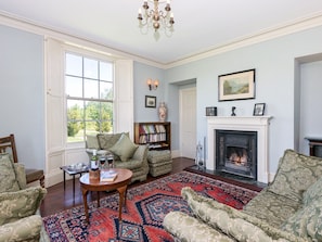 Spacious living room with open fire | Tilney Hall, Kings Lynn
