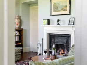 Cosy living room with open fire  | Tilney Hall, Kings Lynn