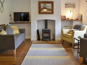 Comfortable living room with wood burner | Primrose Cottage, Gresham 