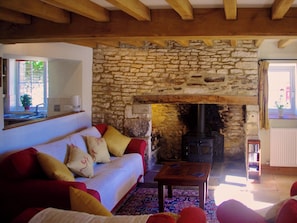 Beamed living room with feature fireplace | Ivy Cottage, Chedworth, near Cheltenham