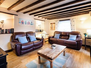 Charming beamed living room with open fire | Pitts Cottage, Brancaster