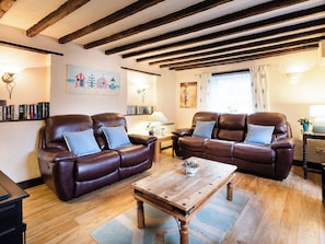 Charming beamed living room with open fire  | Pitts Cottage, Brancaster