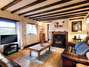 Charming beamed living room with open fire | Pitts Cottage, Brancaster