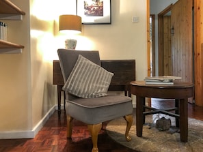 Additional lounge seating and an original millstone in floor | The Mill House, Lea, near Ross-on-Wye