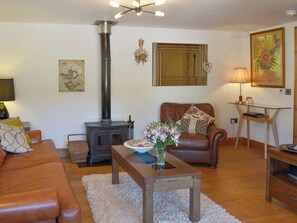 Wood floored living room with wood burning stove | Beer Farm, Waterrow, near Wiveliscombe