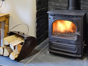 A cosy woodburner is available for guests to use | Capel Fawnog Bach - Capel Fawnog Mawr and Capel Fawnog Bach, Talsarnau near Harlech