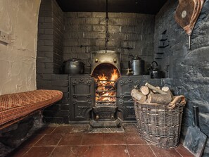 Living room with cobbled floor, open fire and many original features | Pen Copi, Trefeglwys, near Caersws