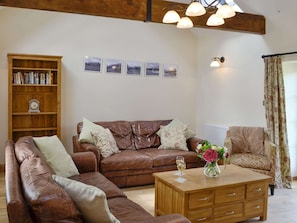 Characterful living room with exposed wood trusses | Sgubor Ucha, Llanrhychwyn, Trefriw