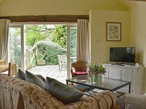 Welcoming living area with French doors to garden | The Old Forge, Lower Wraxall, near Dorchester