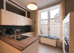 Fully equipped kitchen with microwave, oven, dishwasher,  coffee machine,..