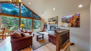 living area with gas fireplace and river views