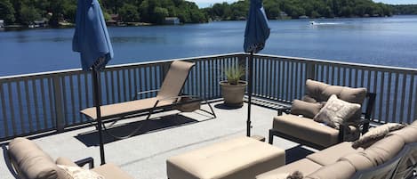 Deck on Boathouse literally extends over the lake.  Comfy new furniture thru-out