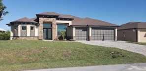 Front view of this newer elegant home on the water 