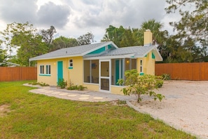 Cottage is set back in quiet neighborhood.