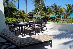 Deck overlooking ocean with complete dining room set for 8 people