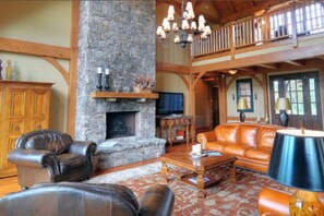 Main living room with fireplace on main floor level, interior front side,